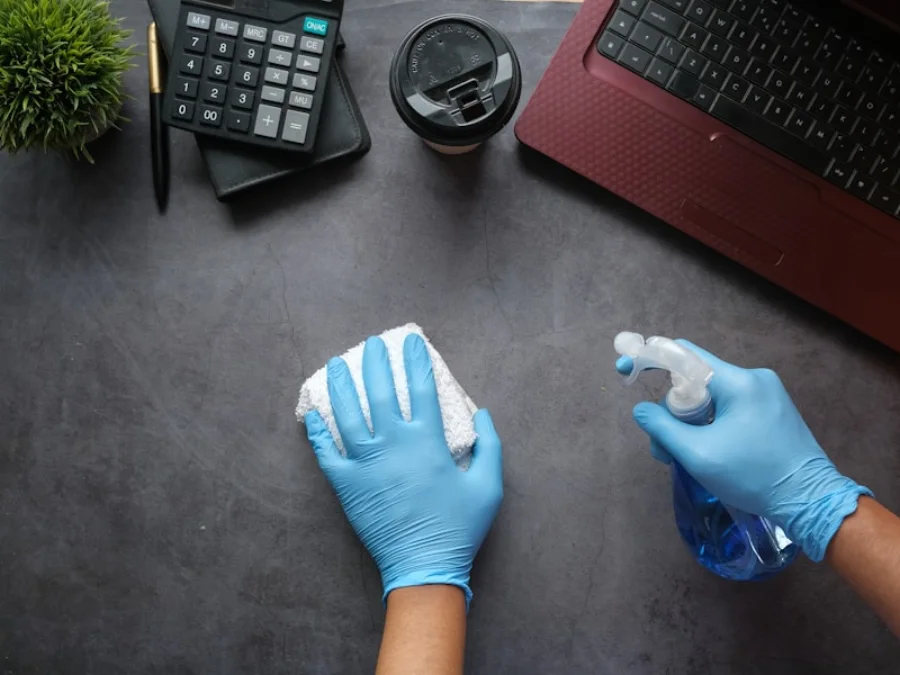 Gloved professional performing a cleaning task